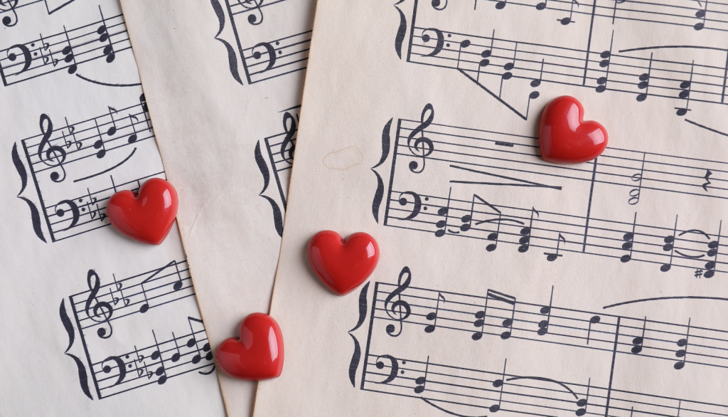 Phone-Sex-Mistress-Sascha-Valentines Day Sheet Music in Background with Red Candy Hearts-800-601-6975