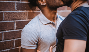 LGBTQ-Pride-Two-Men-Kissing-2-One Man Against A Brick Wall Phone-Sex-Mistress-Sascha-800-601-6875